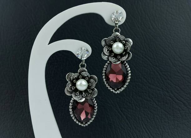 Elegant stainless steel earrings adorned with sparkling gemstones and intricate patterns
